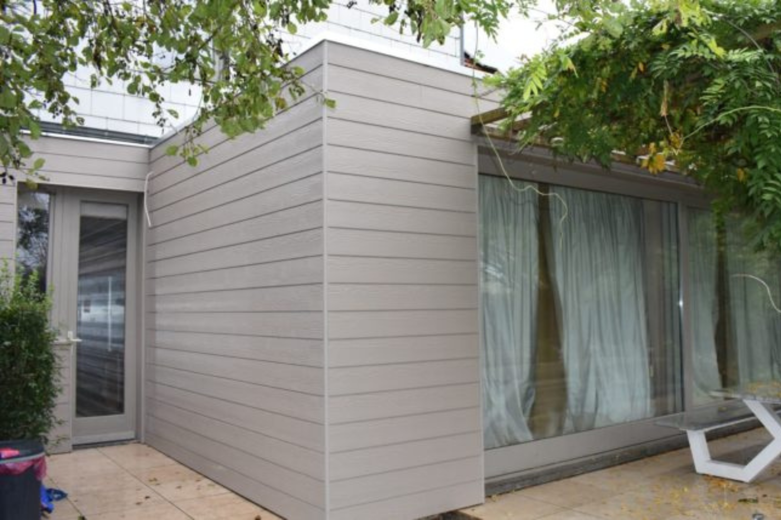 Gevelbekleding met grijze houtlook sidings op tuinkamer in Drogenbos